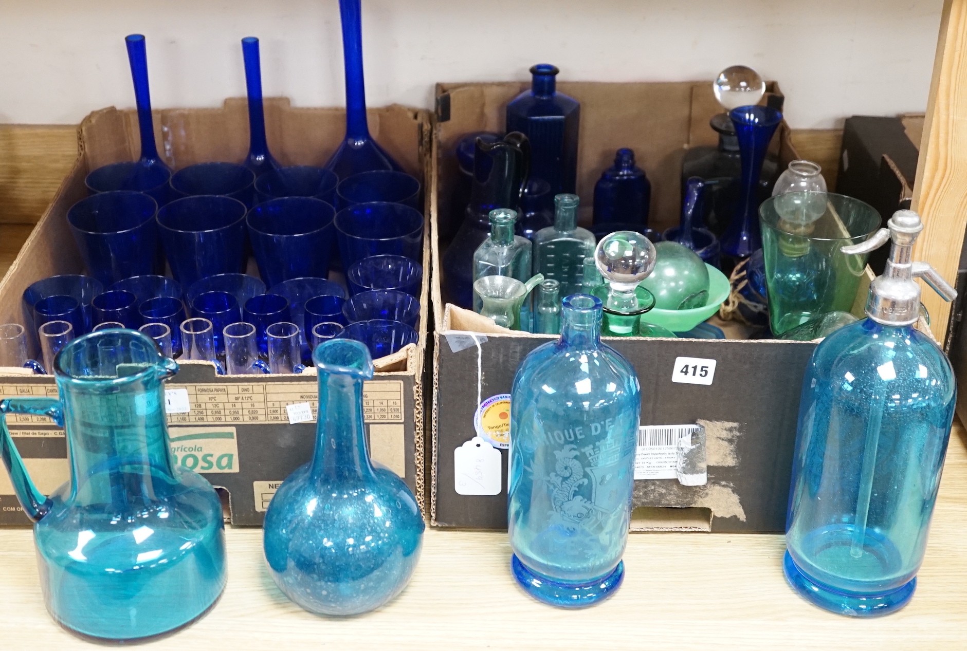 A collection of dark blue, green and turquoise coloured glassware, including three long stemmed glasses